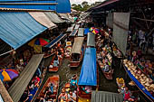 Thailand, Locals sell fruits, food and products at Damnoen Saduak floating market near Bangkok 